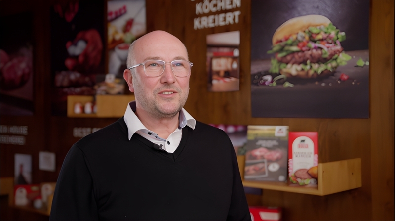 Production manager discussing quality assurance in meat processing